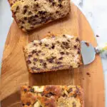 a sliced loaf of sourdough banana bread on a cutting board.