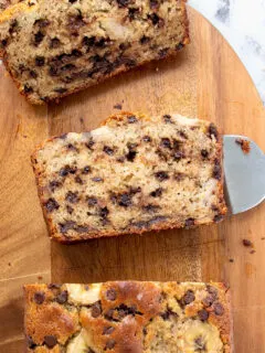 a sliced loaf of sourdough banana bread on a cutting board.