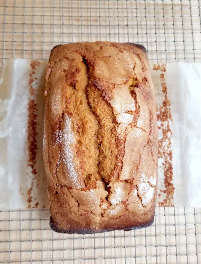 a loaf of pumpkin bread on a cooling rack.