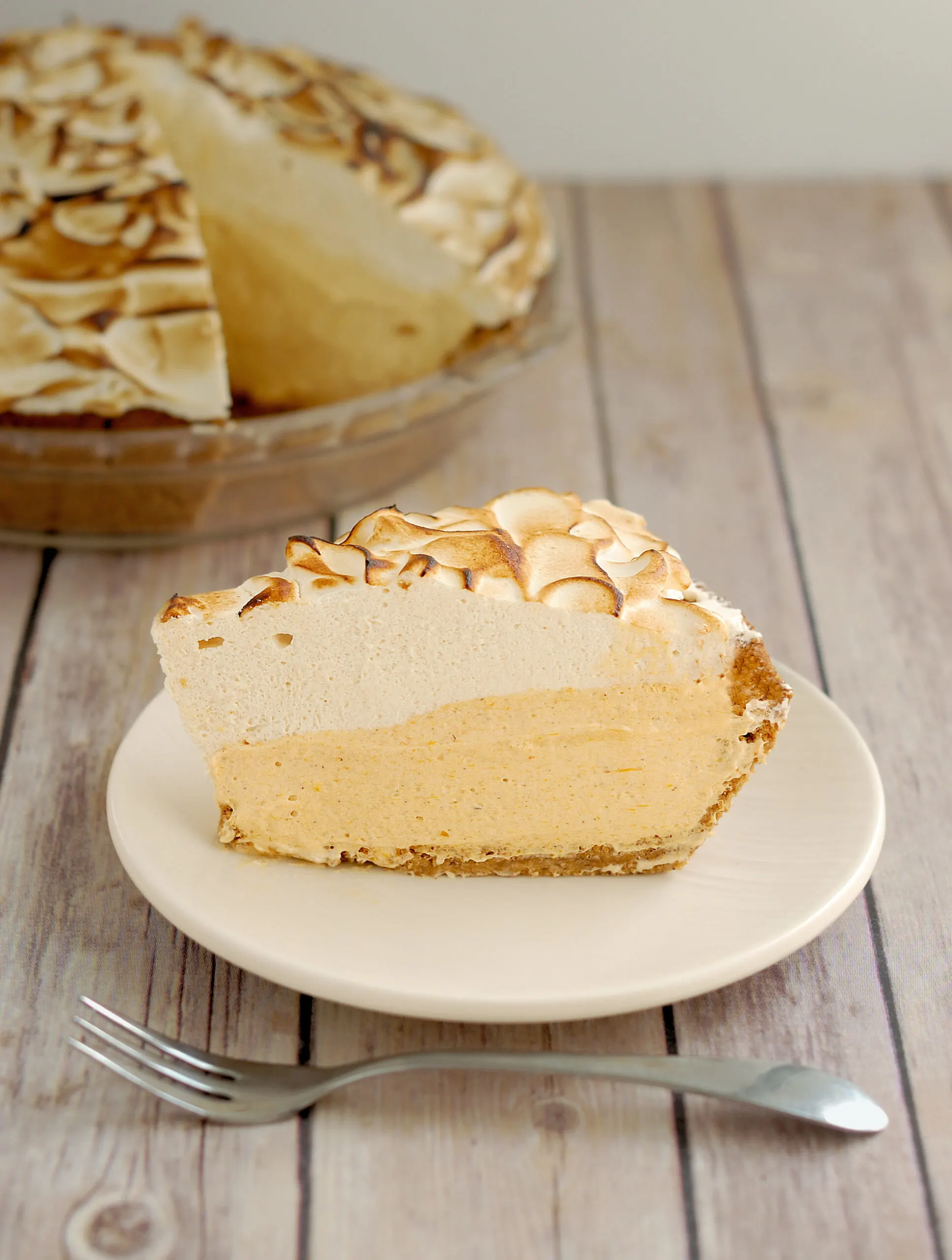 a slice of pumpkin mousse pie on a white plate.