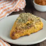 a pumpkin scones on a white plate.