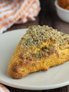 a pumpkin scones on a white plate.
