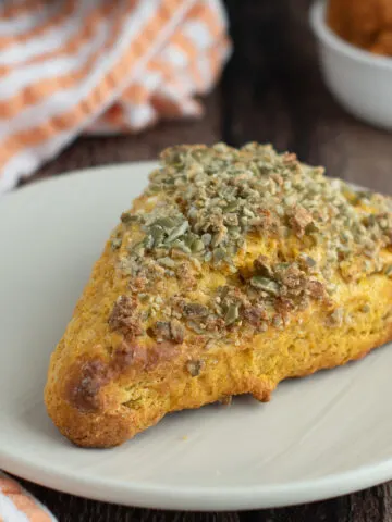 a pumpkin scones on a white plate.