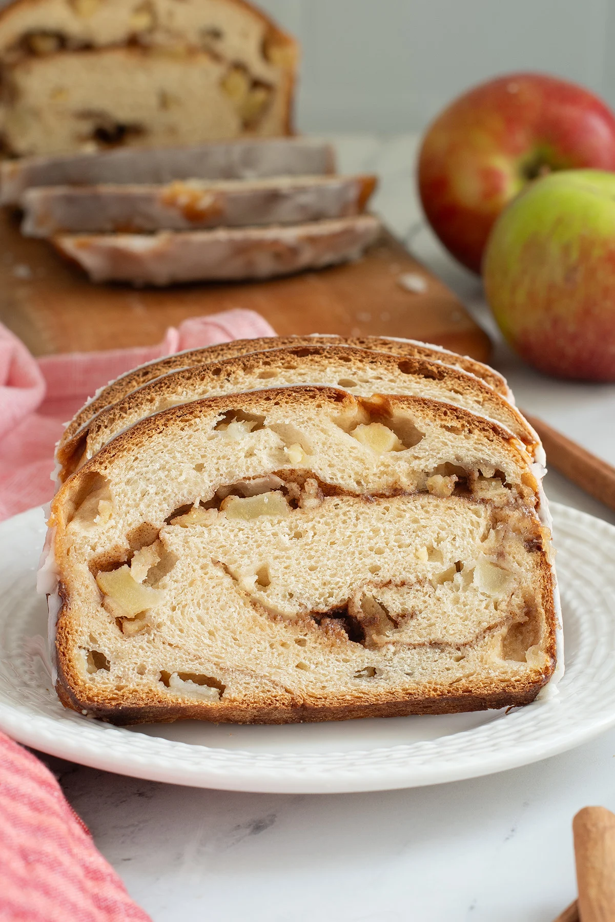 slices of apple cinnamon bread on a white plate.
