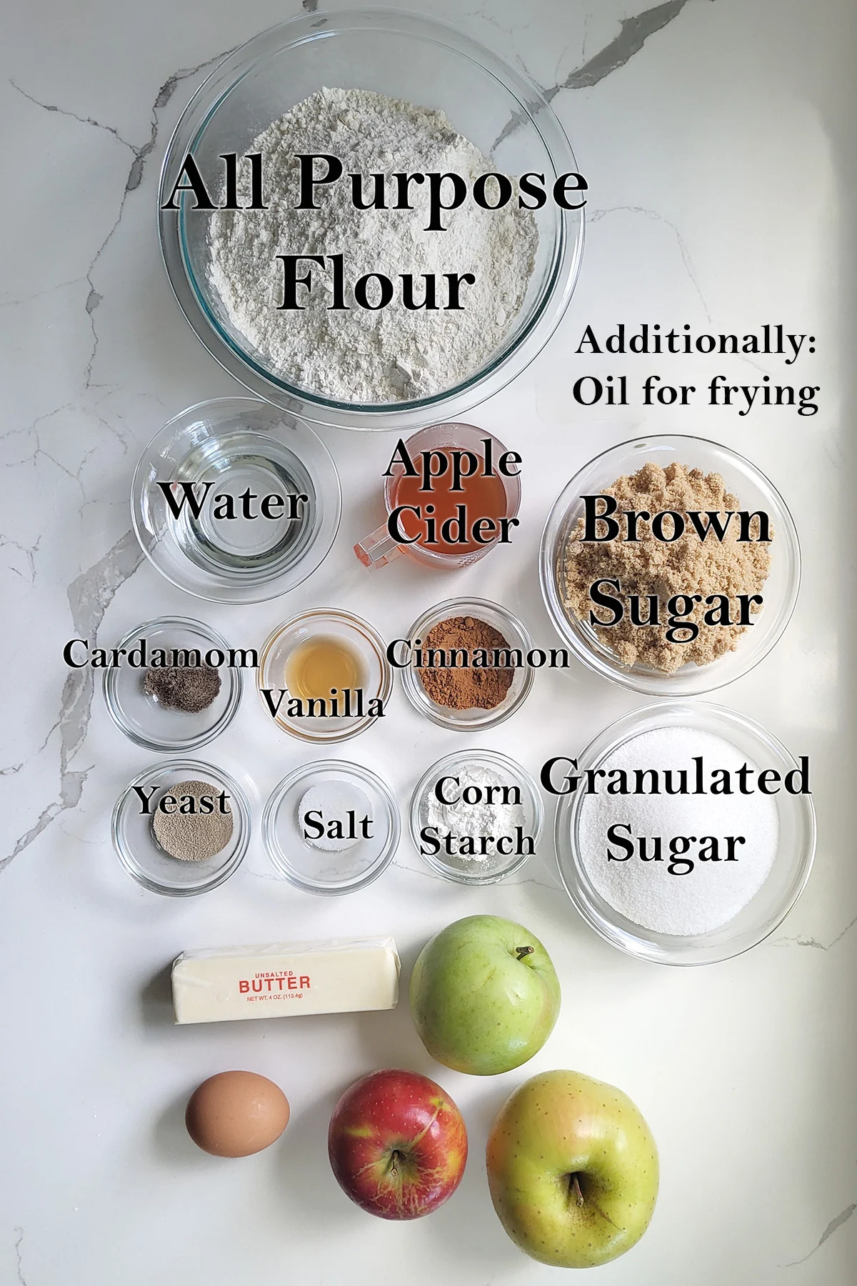 ingredients for apple filled donuts in glass bowls.