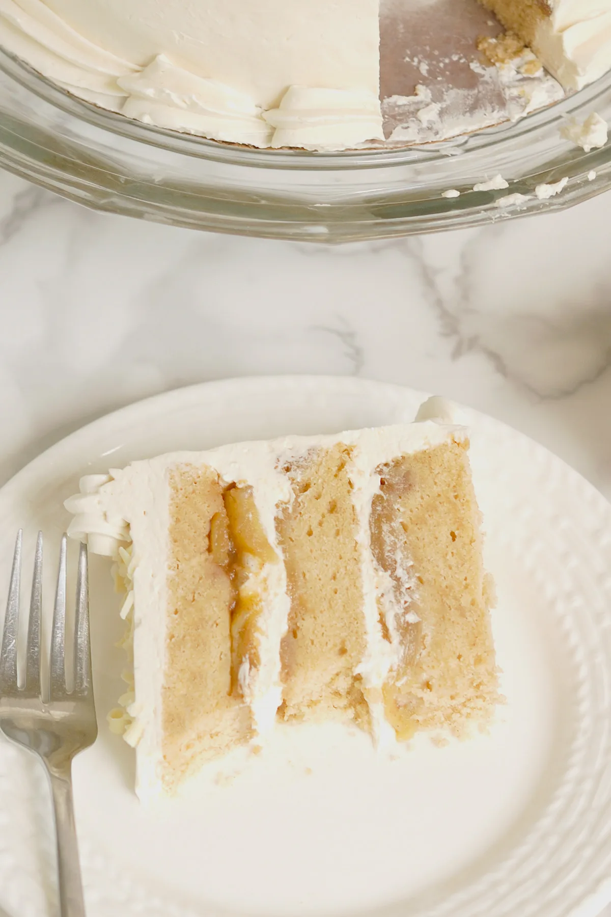 A slice of cake on a white plate.