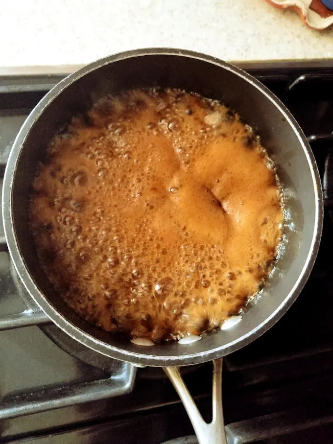 caramel boiling in a pot.