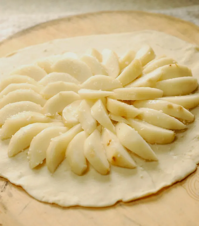 a round of dough covered with sliced pears.