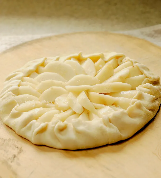 a pear galette on a pizza peel.