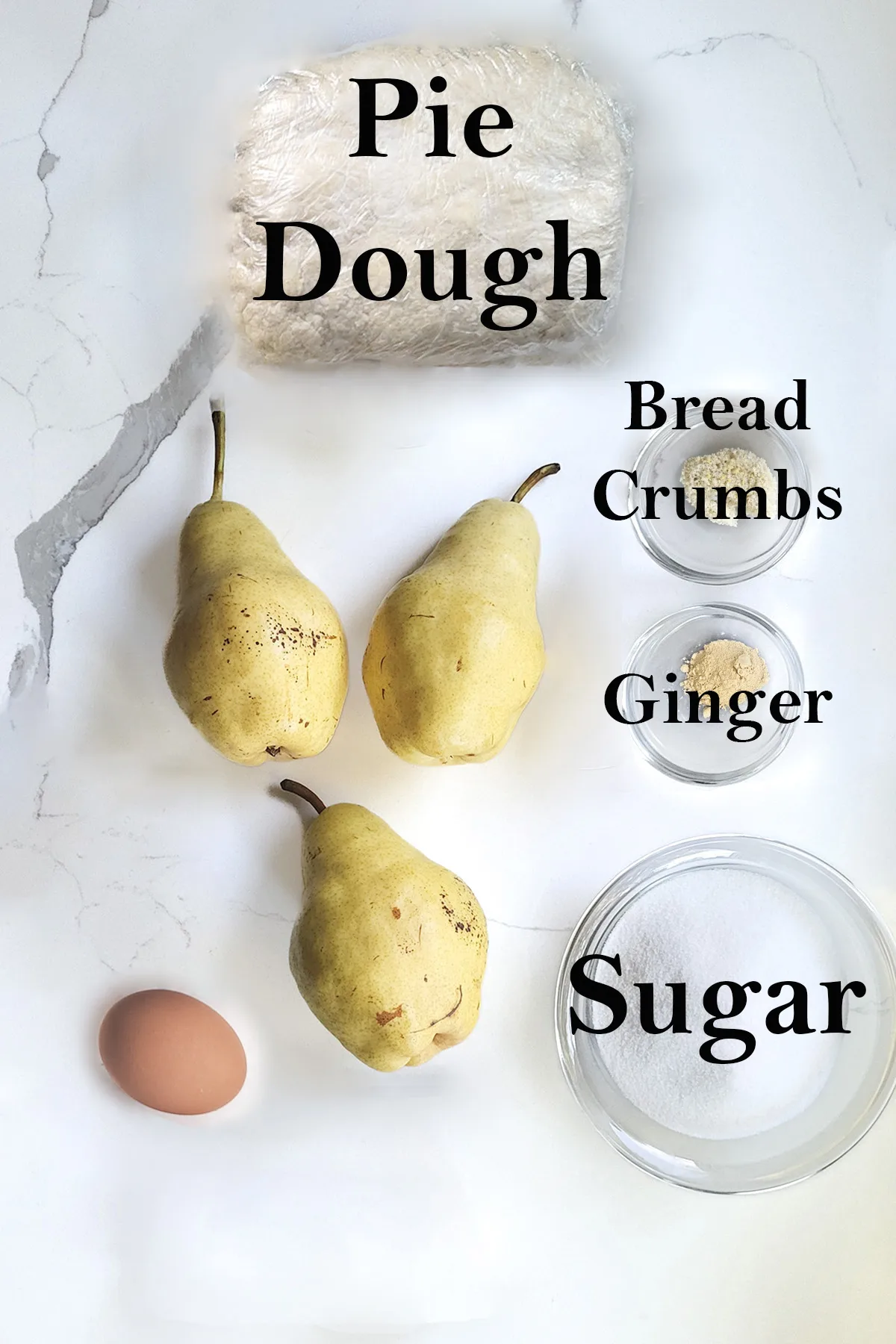 ingredients for pear galette on a white surface.