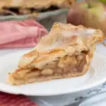 a slice of apple pie on a plate.