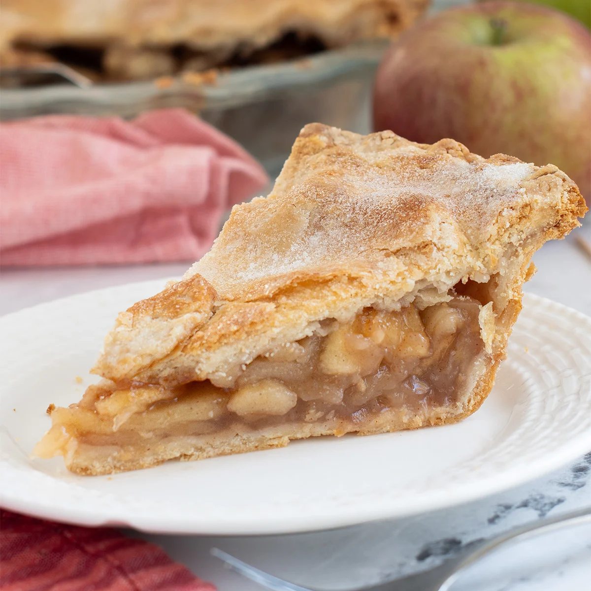 a slice of apple pie on a plate.