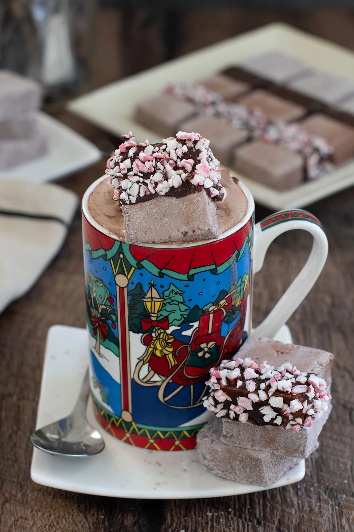 a mug of hot chocolate topped with chocolate marshmallows.