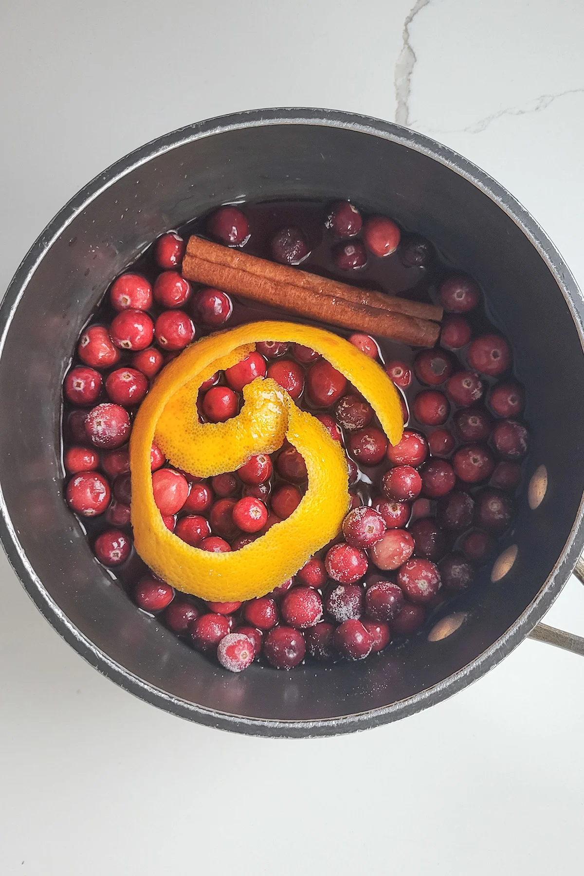 ingredients for cranberry compote in a pot.