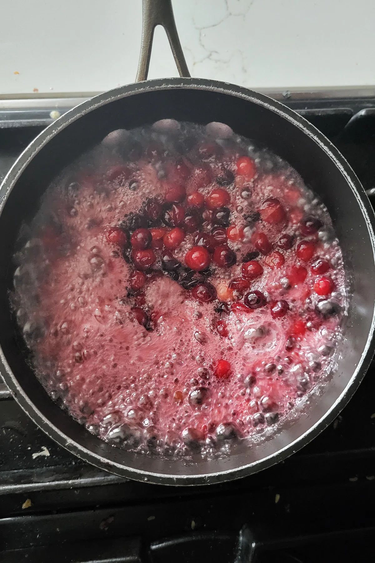 a pot of cranberry compote boiling.