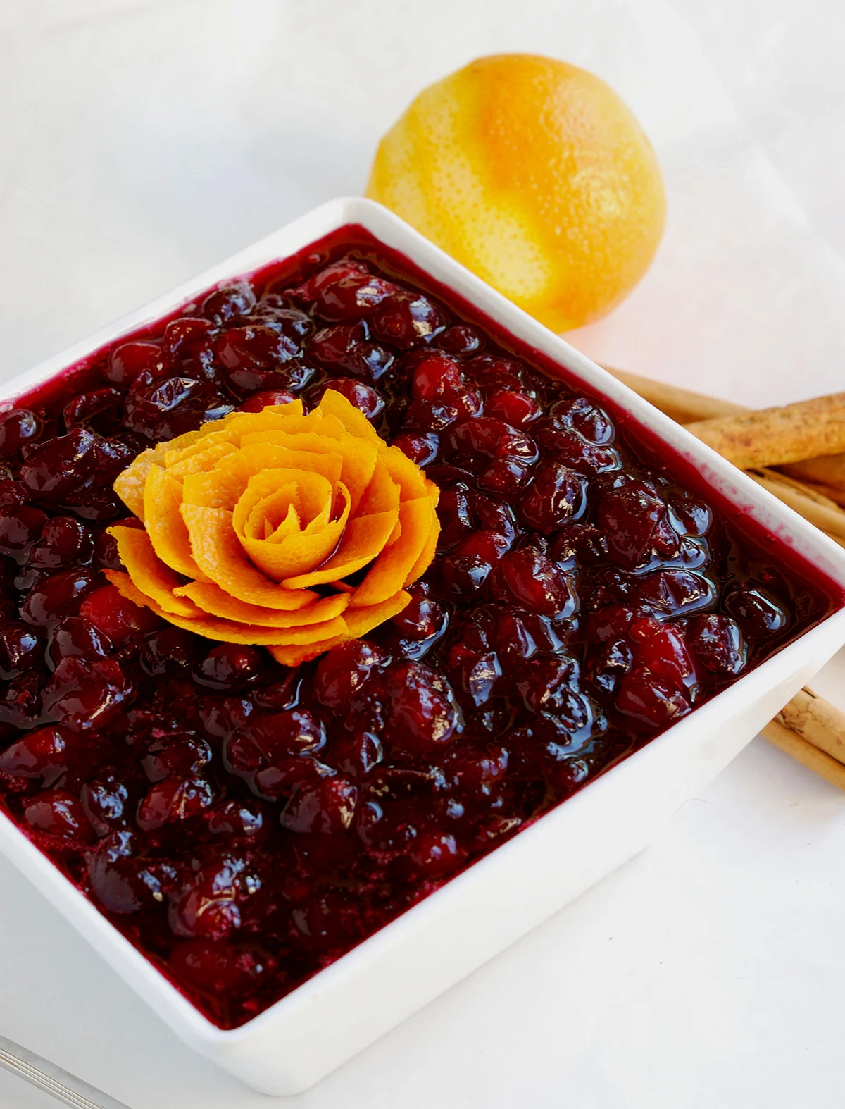 a bowl of cranberry compote with orange zest.