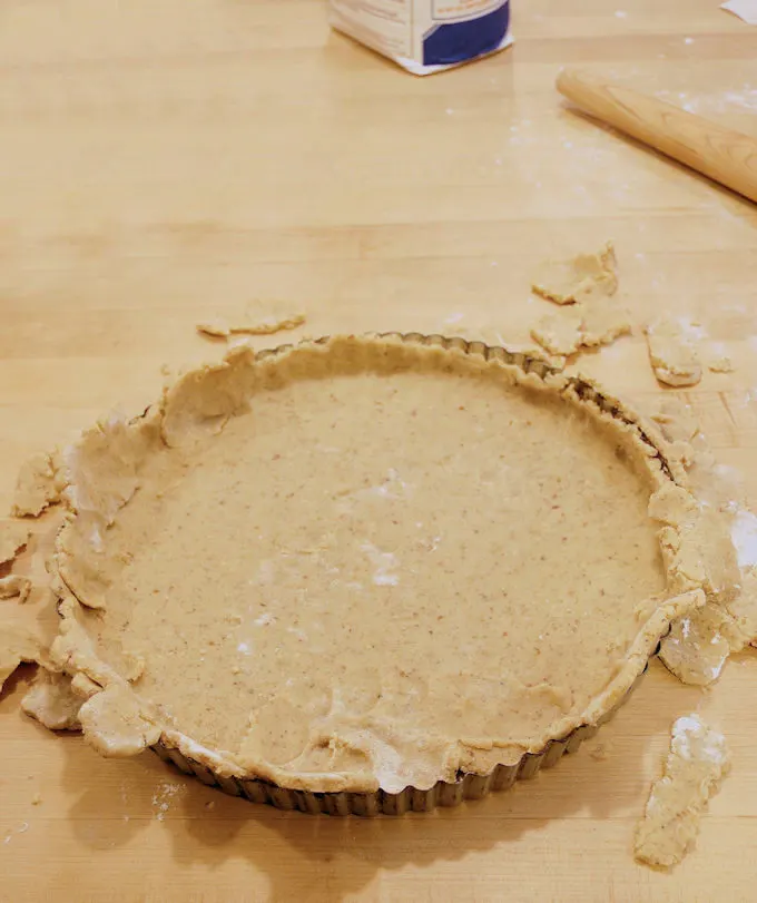 a tart pan lined with dough.