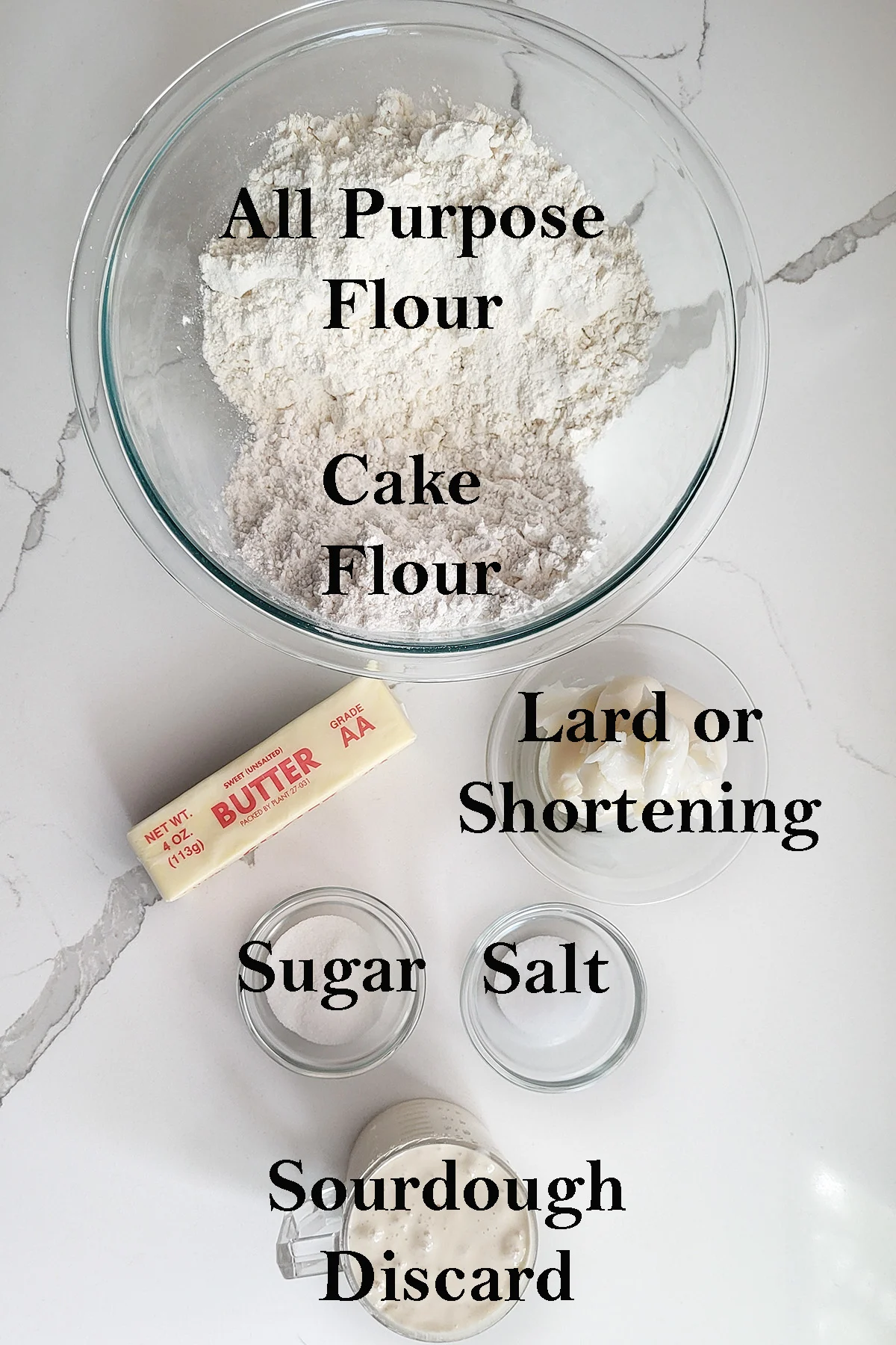 ingredients for sourdough pie crust in glass bowls.