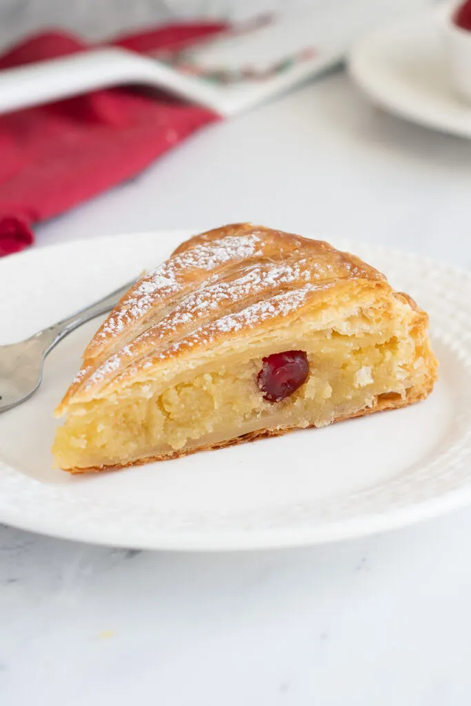 a slice of galette des rois on a white plate.