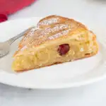 a slice of galette des rois on a white plate.