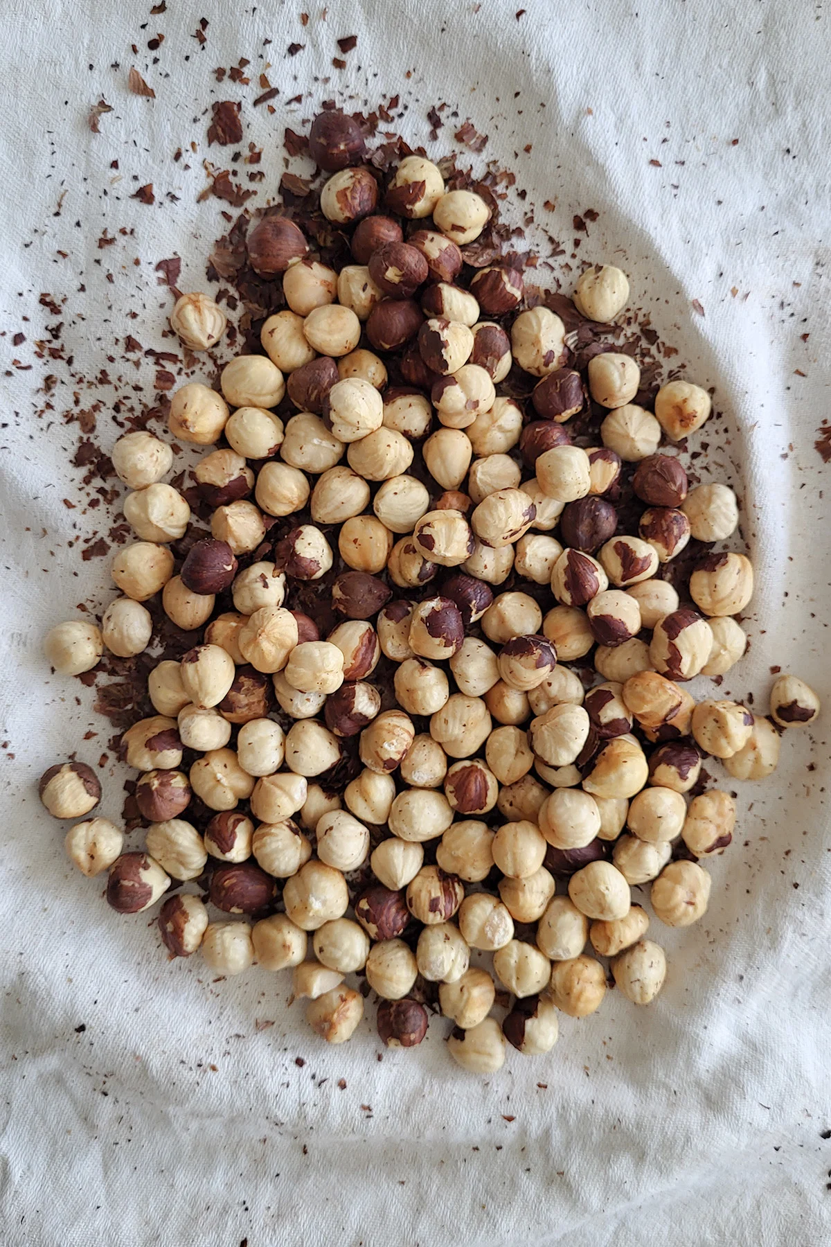 toasted hazelnuts on a kitchen towel.