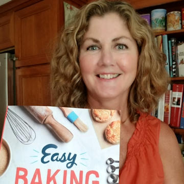 woman holding cookbook.