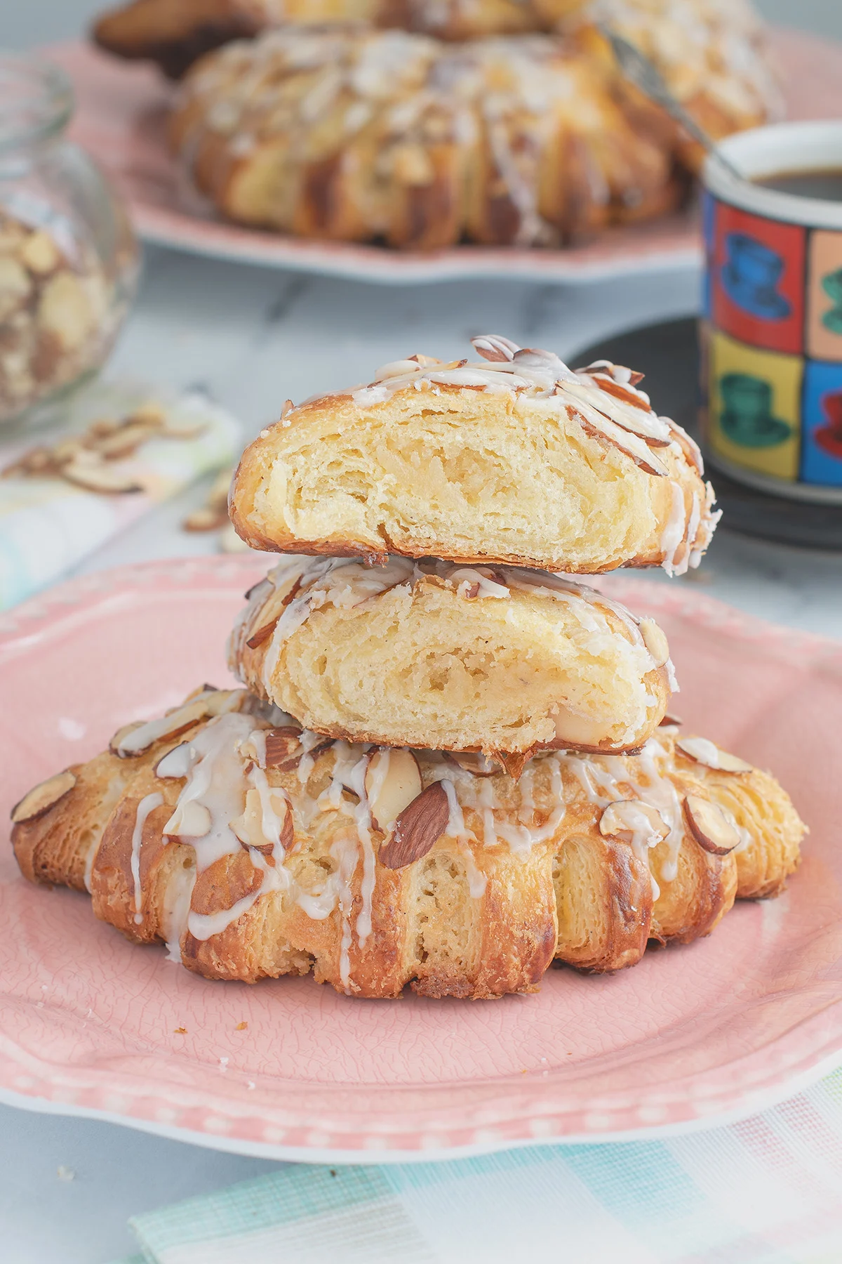 a sliced bear claw pastry on a pink plate.