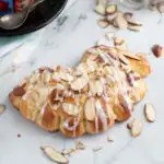 a bear claw pastry on a marble surface.