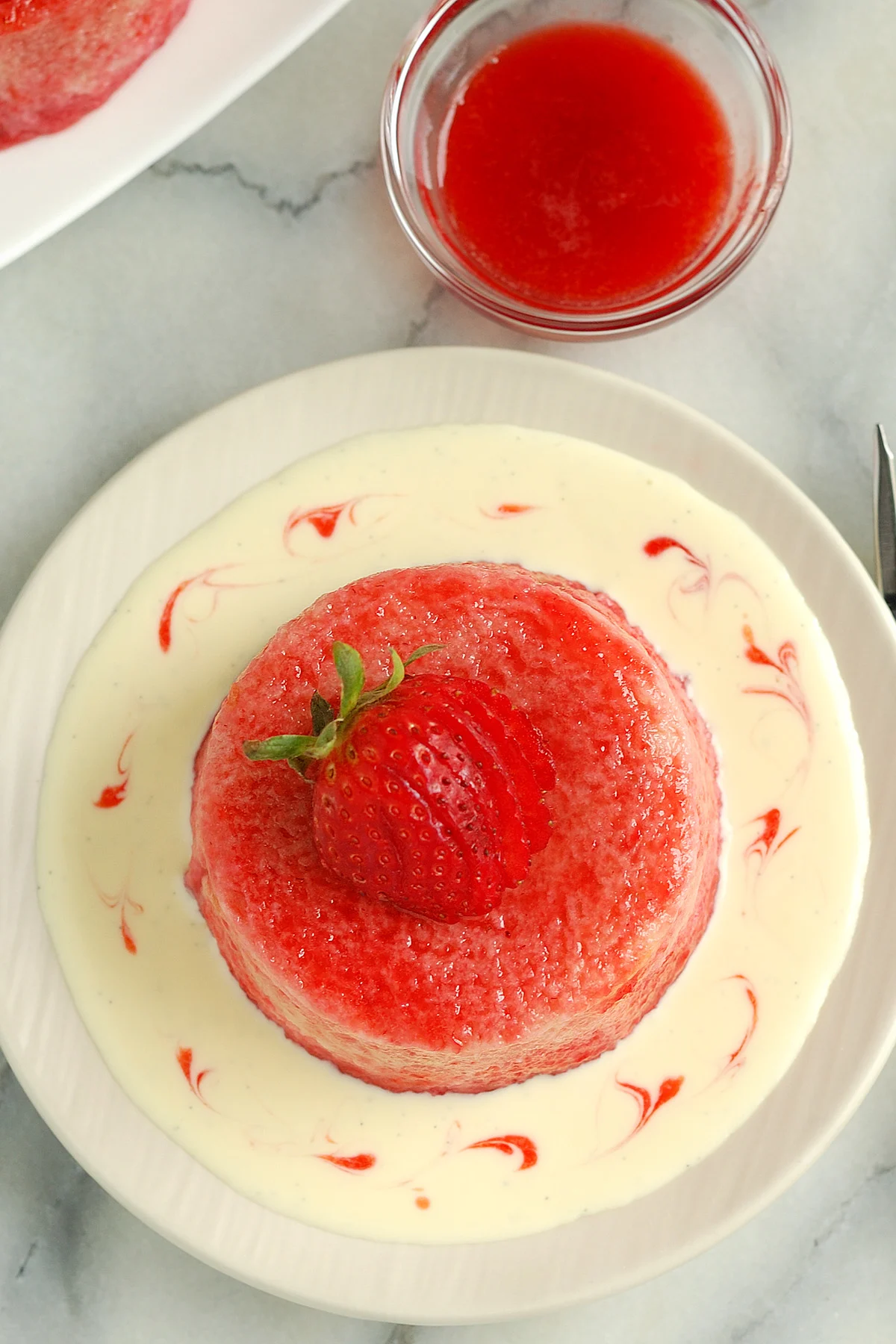 a summer pudding on a plate of creme anglaise.