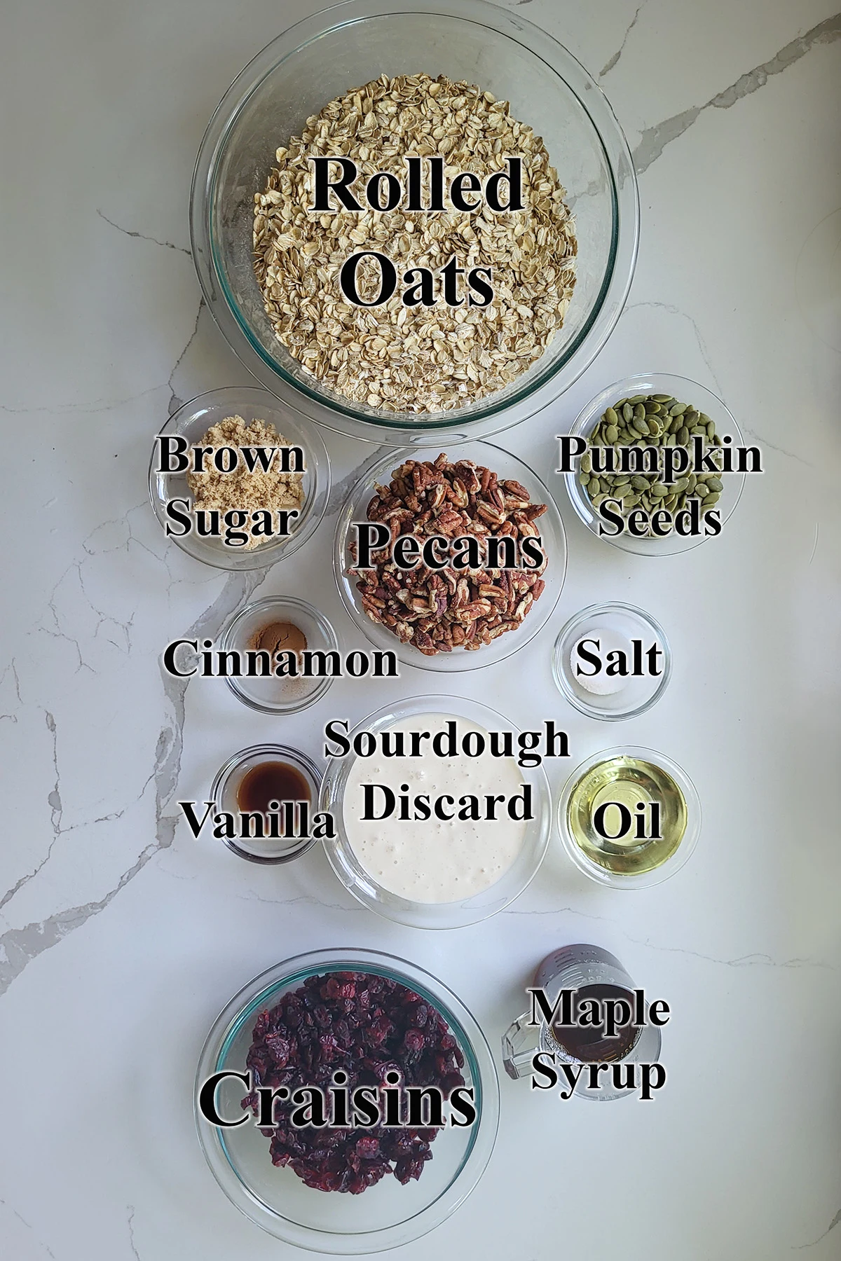 ingredients for sourdough granola in glass bowls.