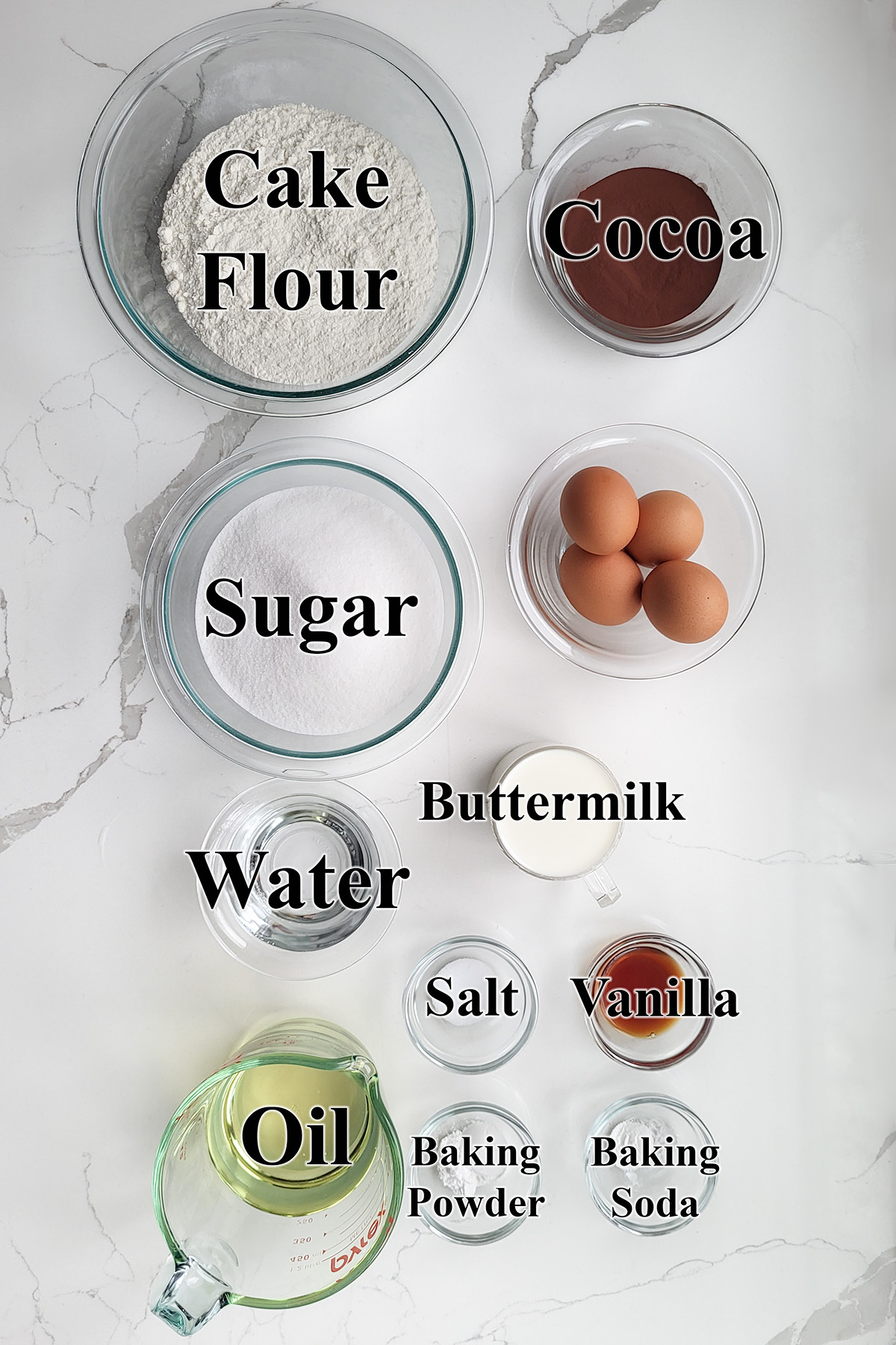 ingredients for chocolate buttermilk cake in glass bowls.