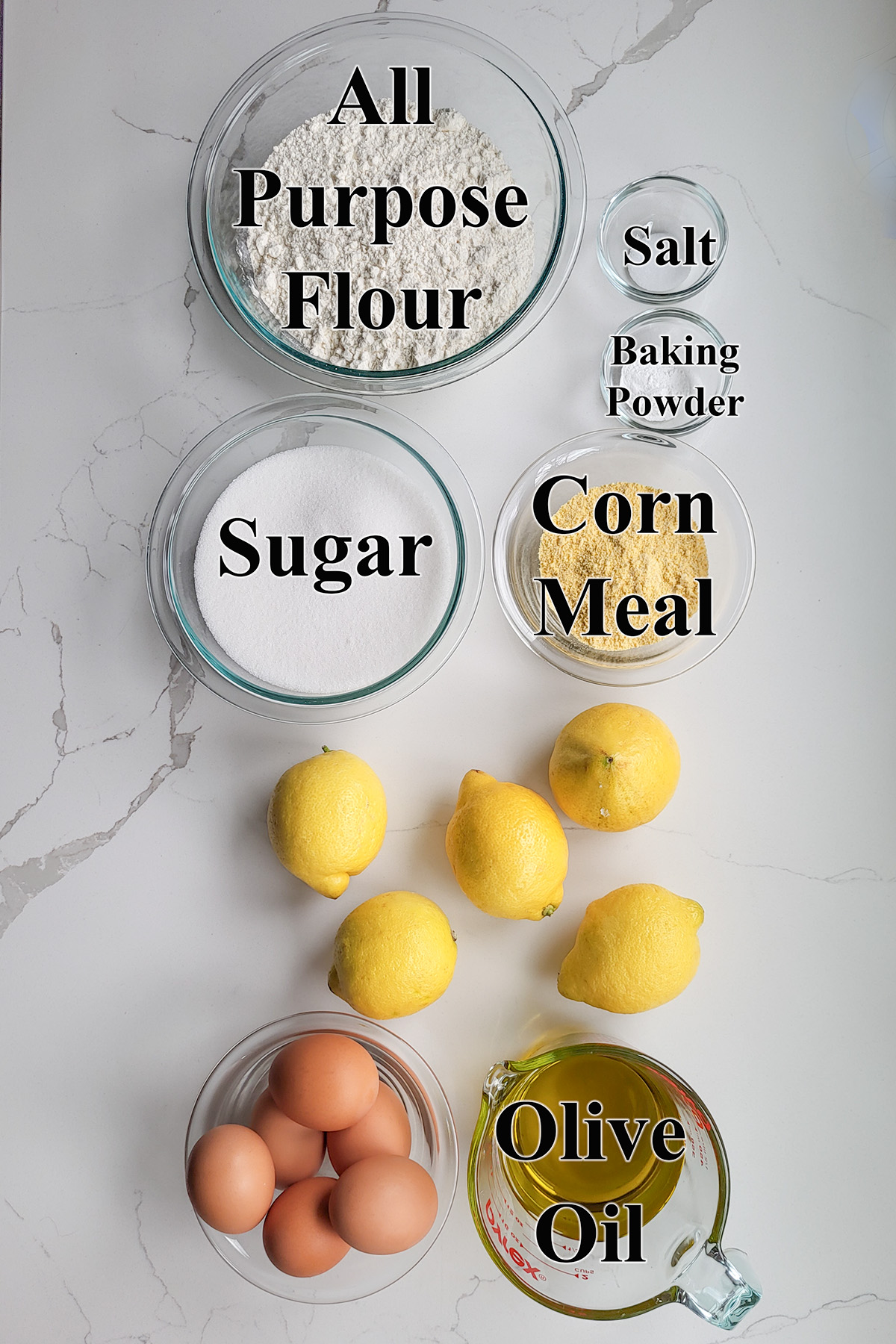 ingredients for lemon olive oil cake in glass bowls.