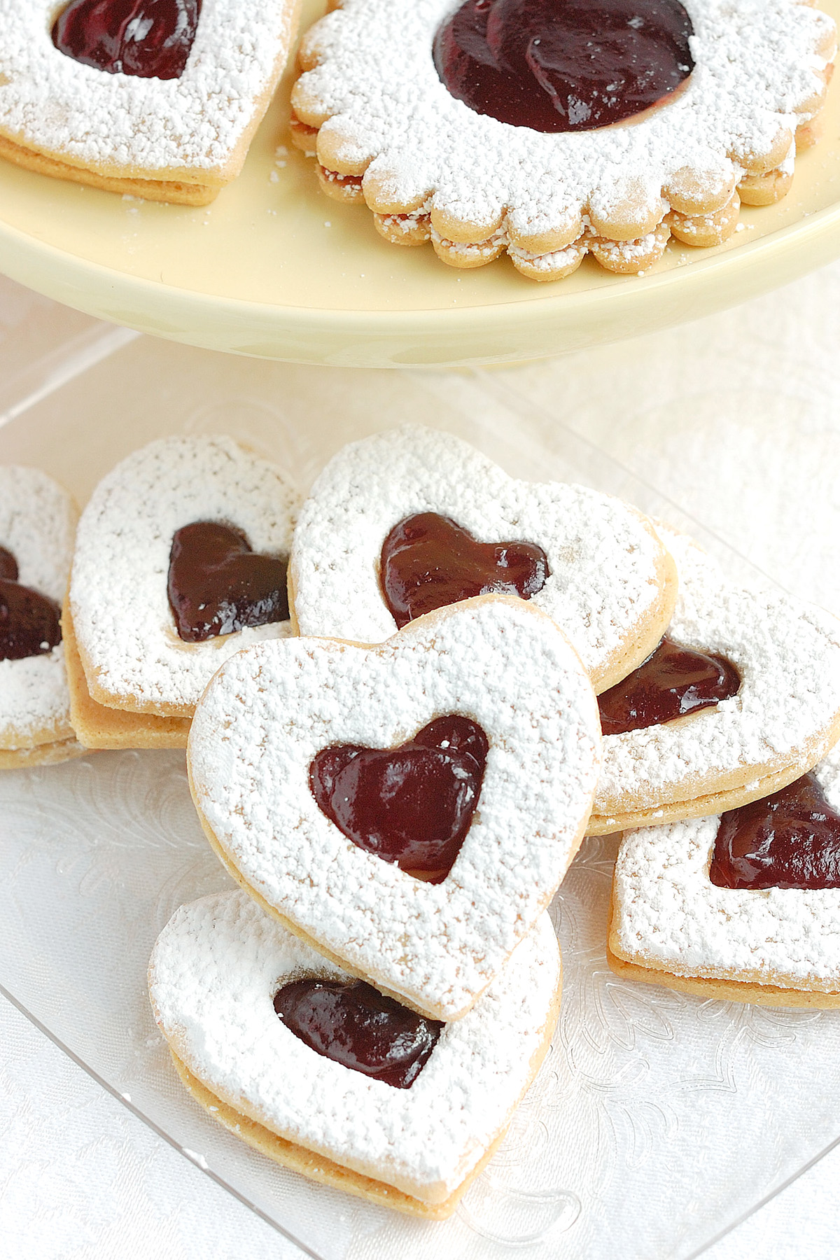 linzer cookies on a white cloth.
