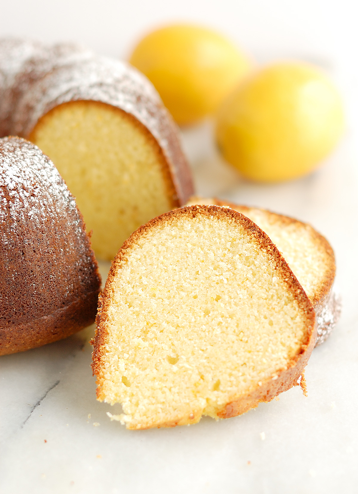 a sliced lemon olive oil cake on a table.