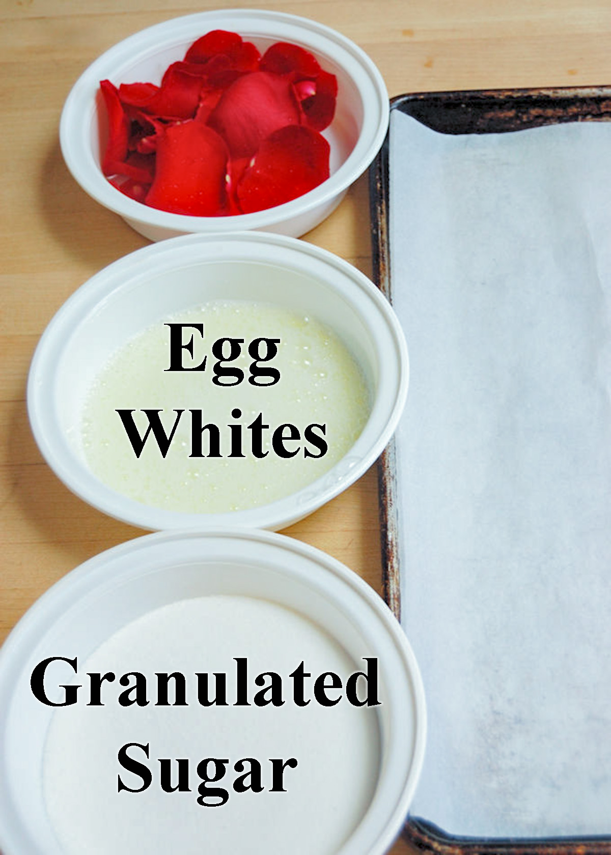 bowls of sugar, egg whites and rose petals. A sheet pan.
