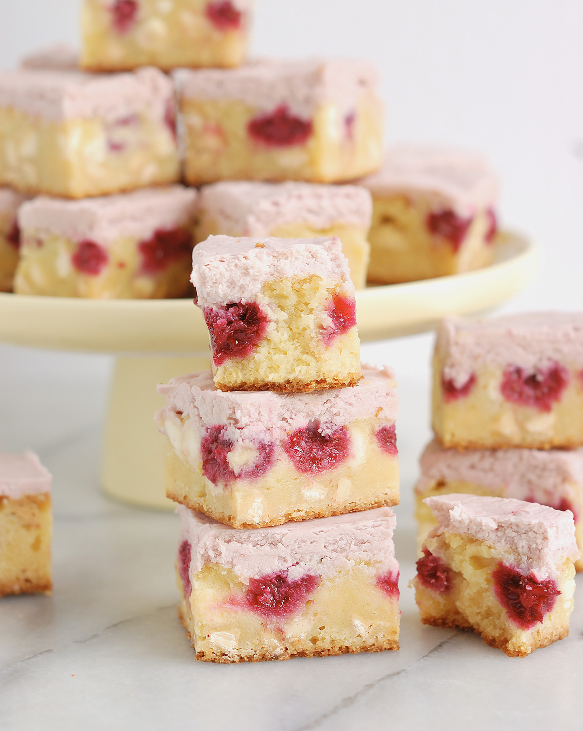 a stack of white chocolate brownies on a table.