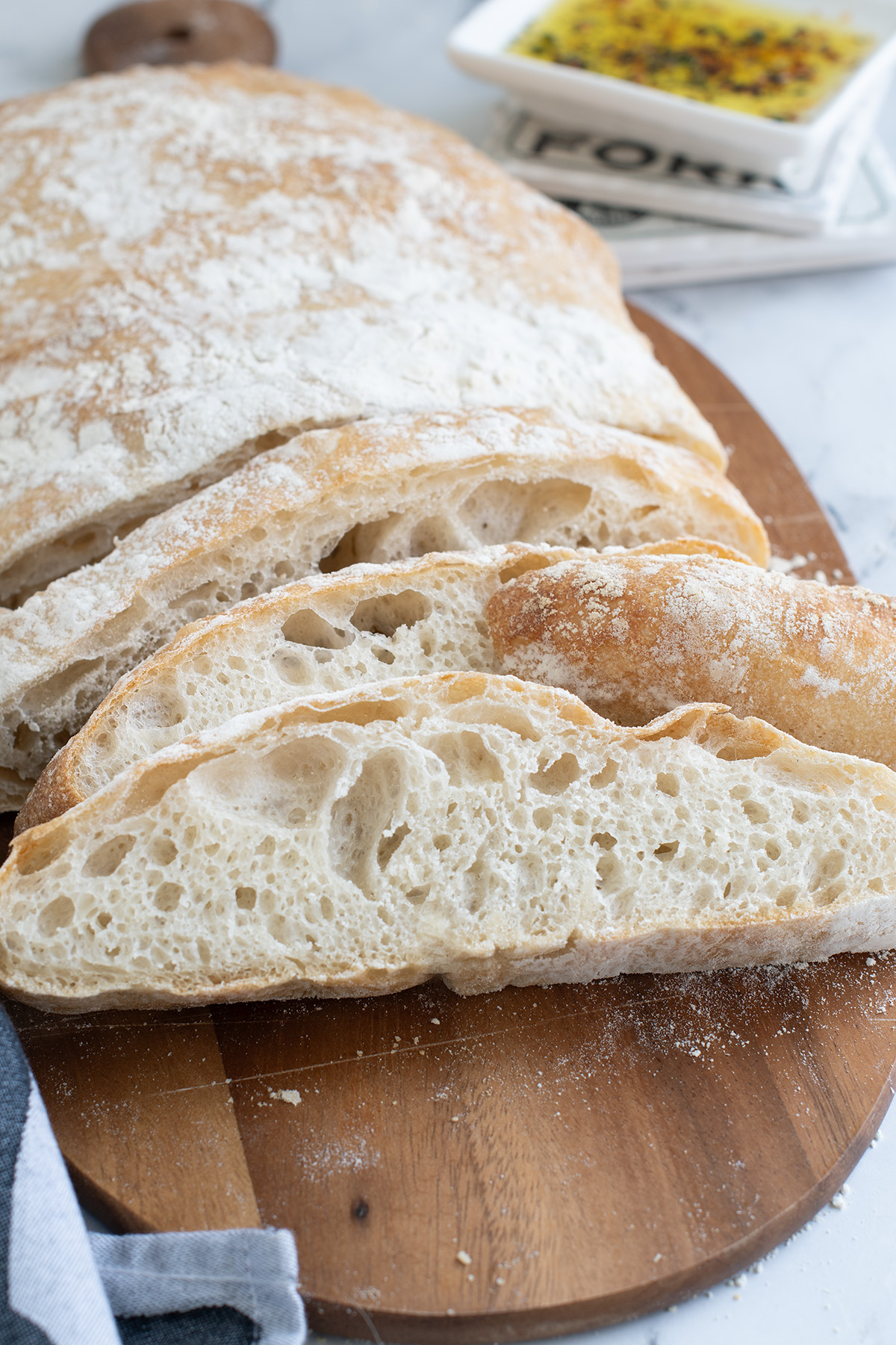 a sliced loaf of ciabatta bread on a cutting board.