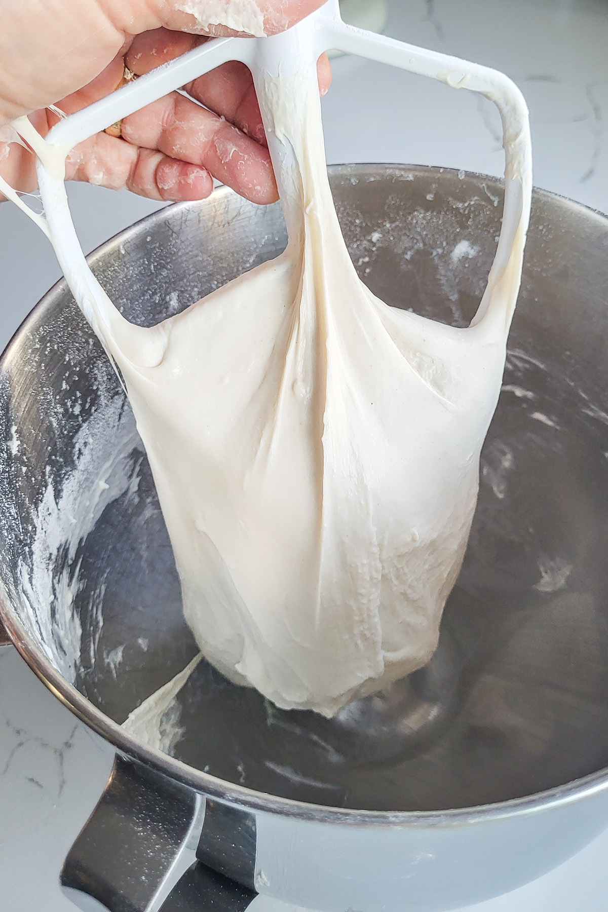 Dough stretched on a mixing paddle.