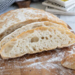 a slice of ciabatta bread on a cutting board.