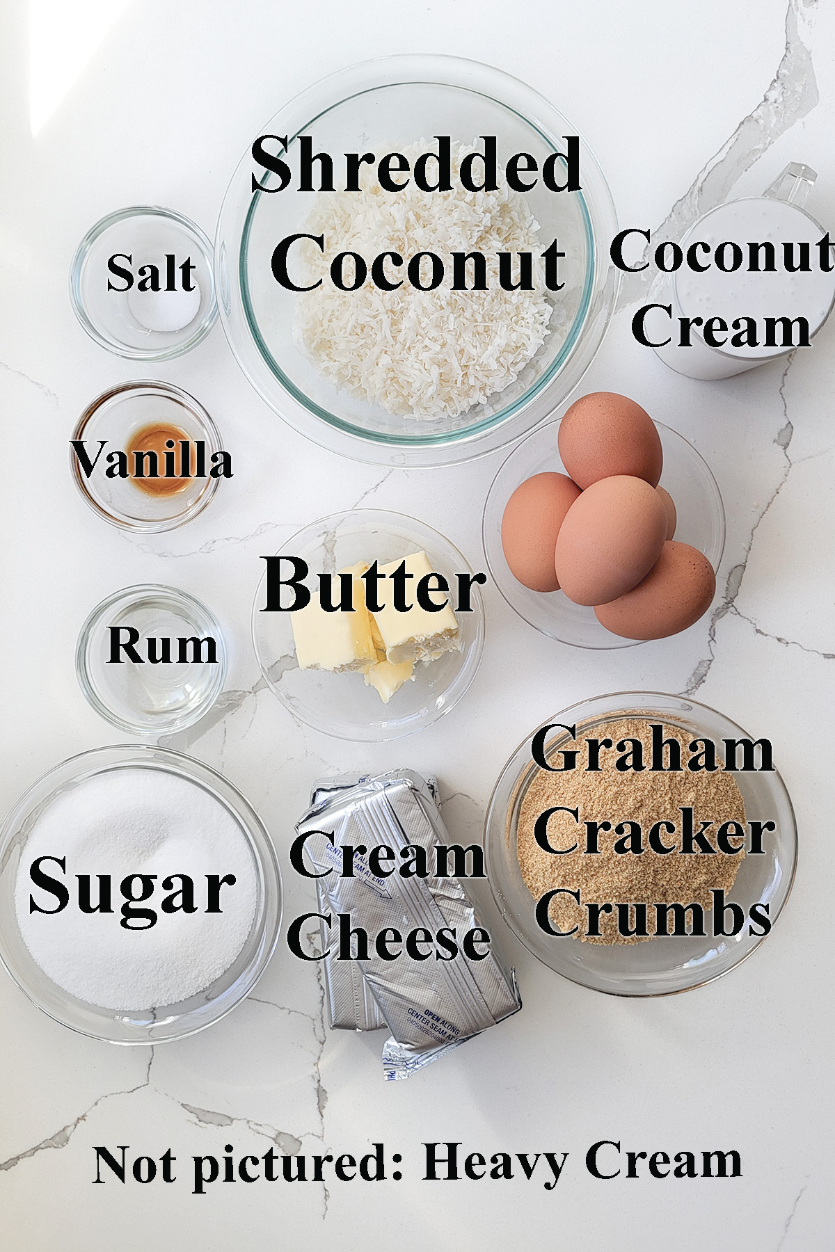 ingredients for coconut cheesecake in glass bowls.