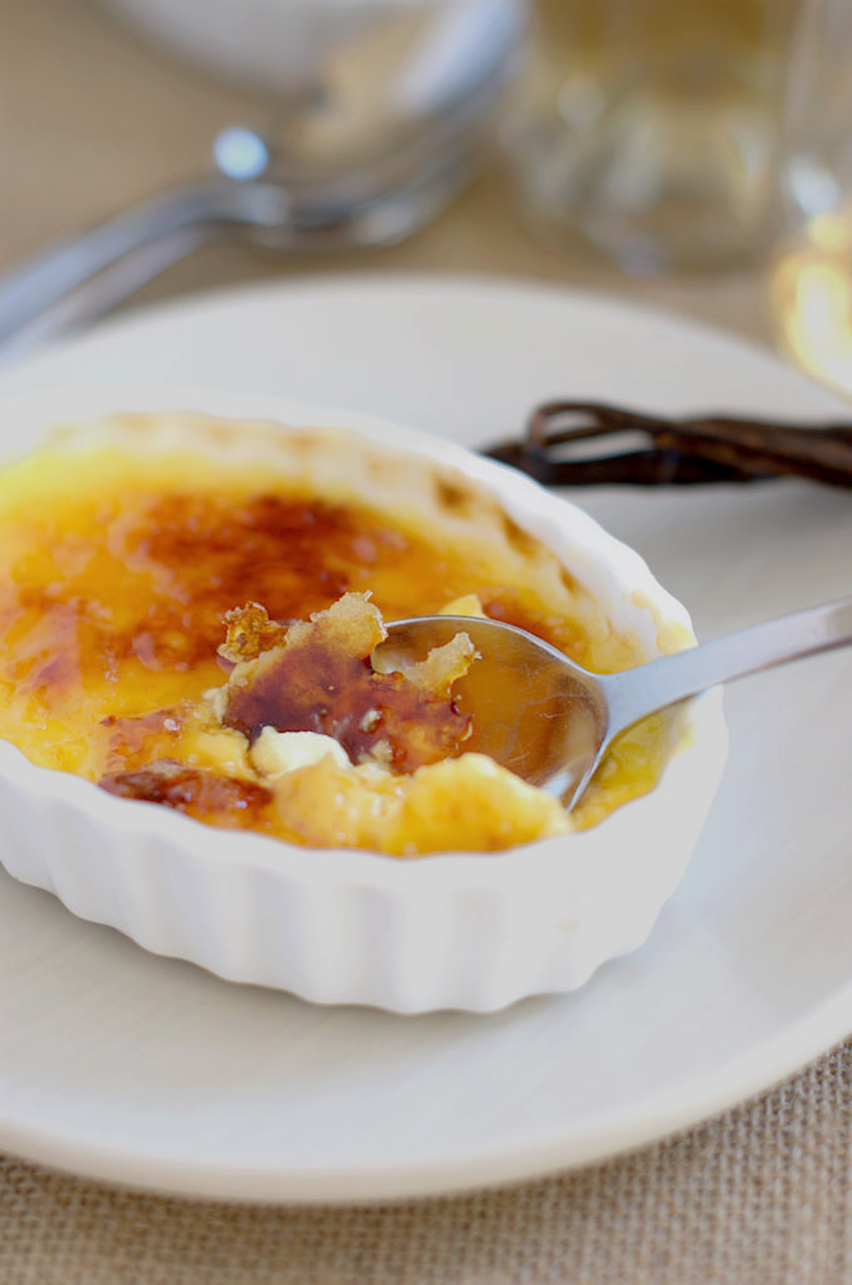 a creme brulee with a spoon in it.