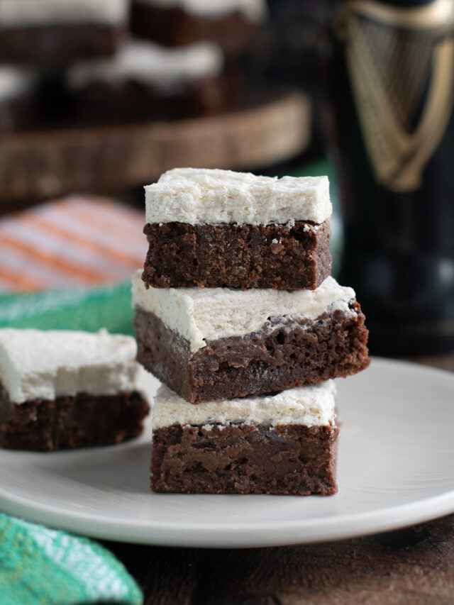 a stack of guinness brownies on a beige plate.