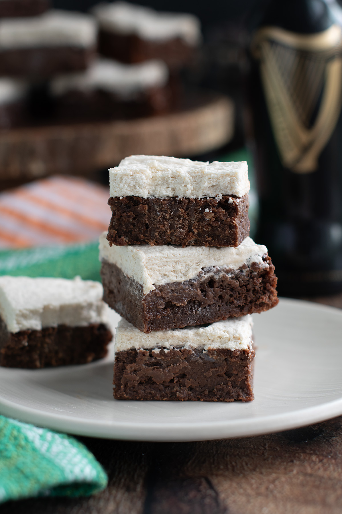 a stack of guinness brownies on a beige plate.