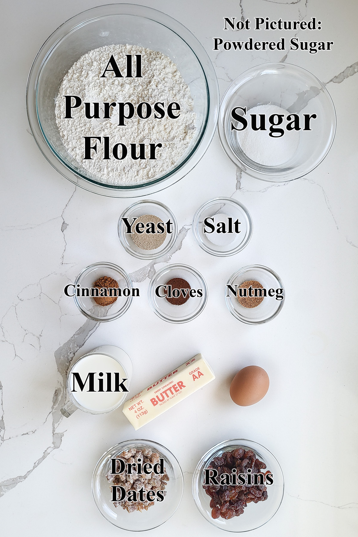 ingredients for hot cross buns in glass bowls.