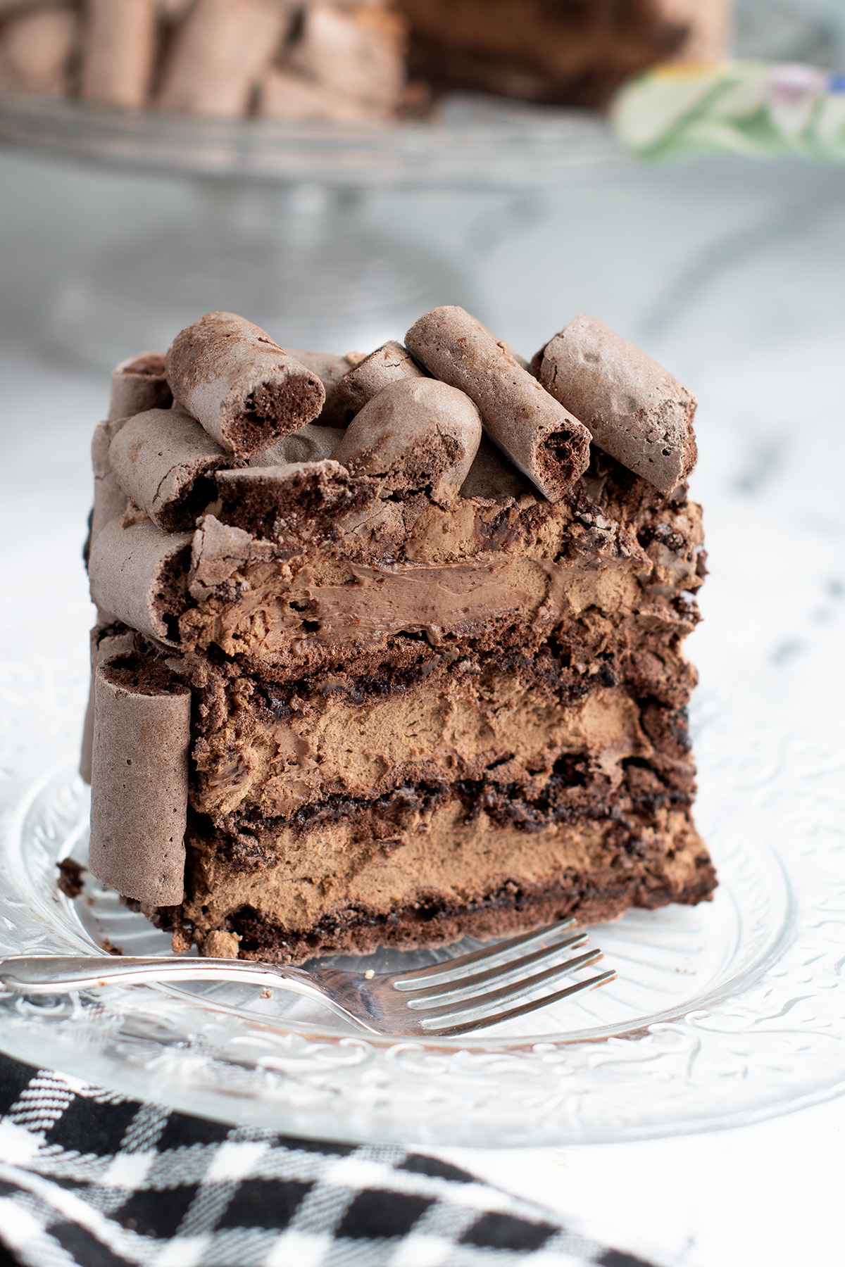 a slice of chocolate cake on a glass plate.