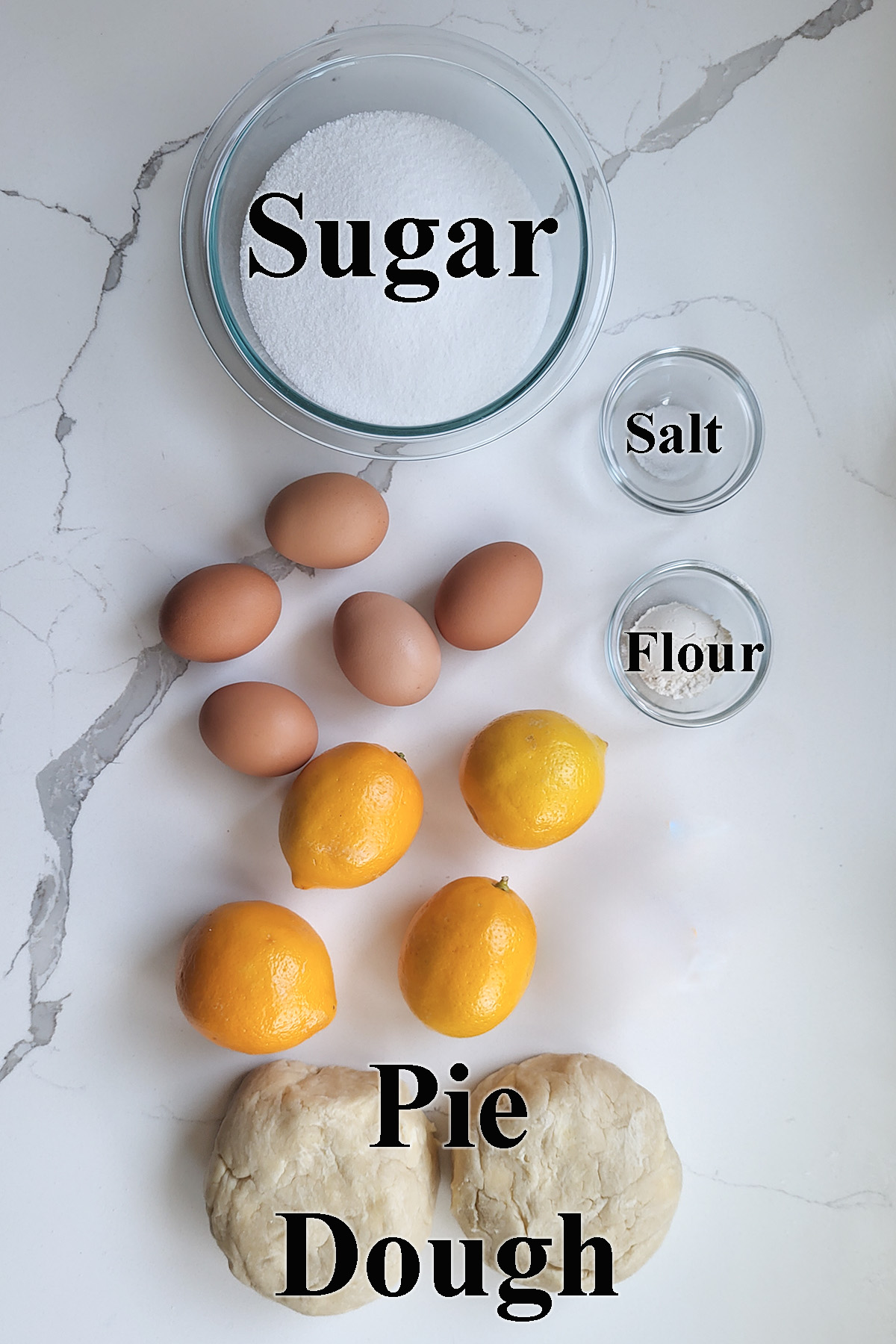 ingredients for lemon shaker pie in glass bowls.