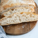 sliced ciabatta bread on a cutting board,.