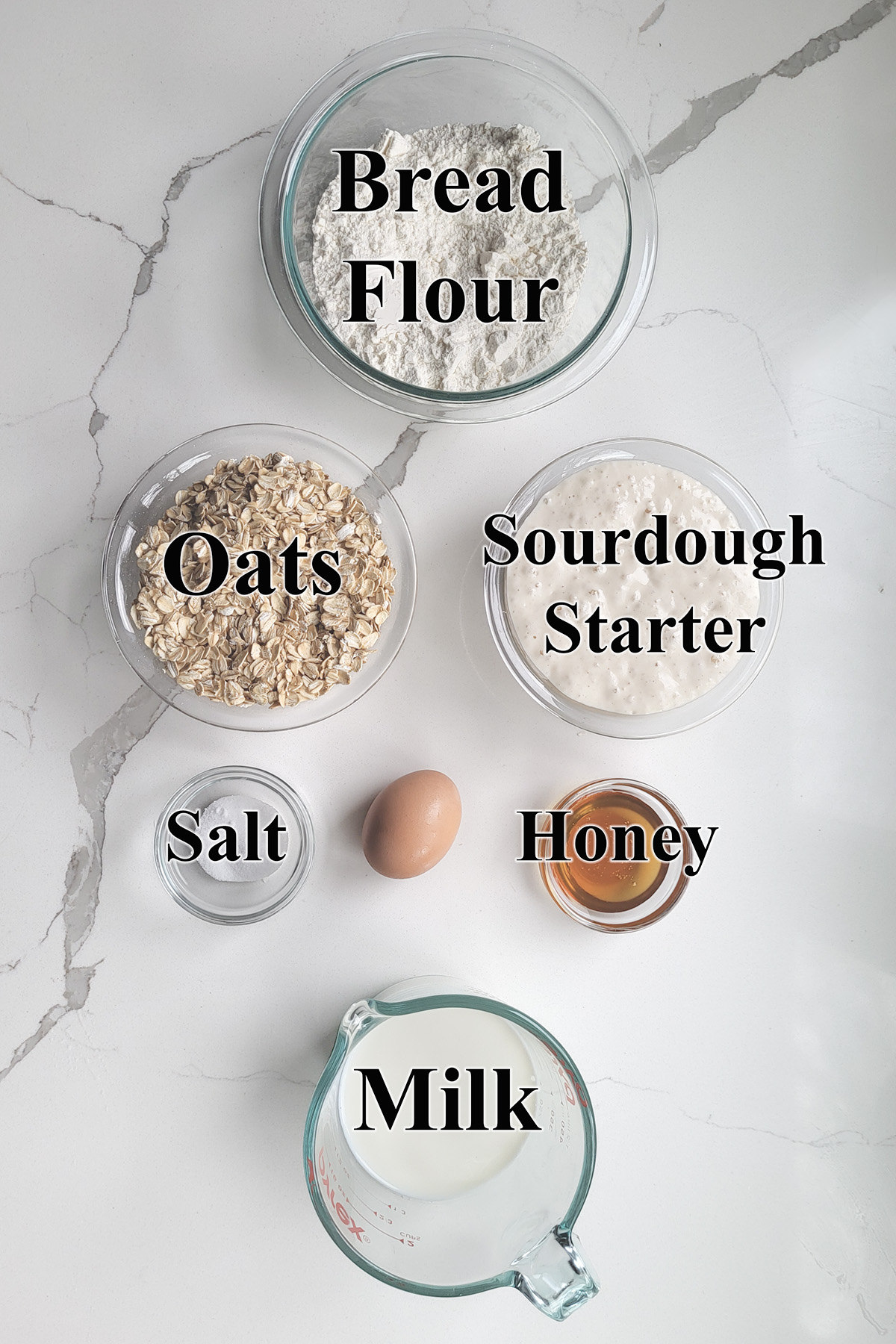 Ingredients for Sourdough Oatmeal bread in glass bowls.