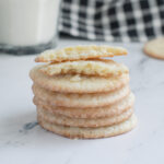 a stack of vanilla wafers on a marble surface.