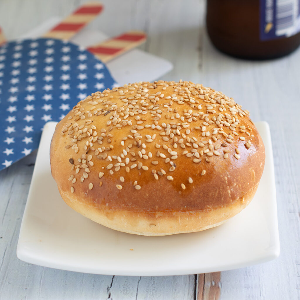 a hamburger bun on a white plate.